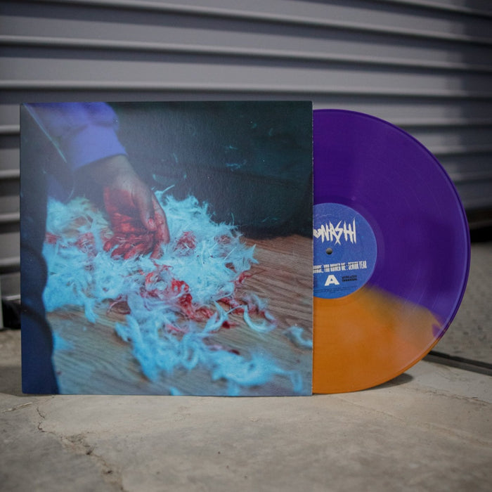 Kaonashi’s limited edition Purple/Metallic Sand Split LP sits by its cover—showing a hand on white and red fur over wood—with a metal garage door behind, making this standout release a must-have for any vinyl collection.