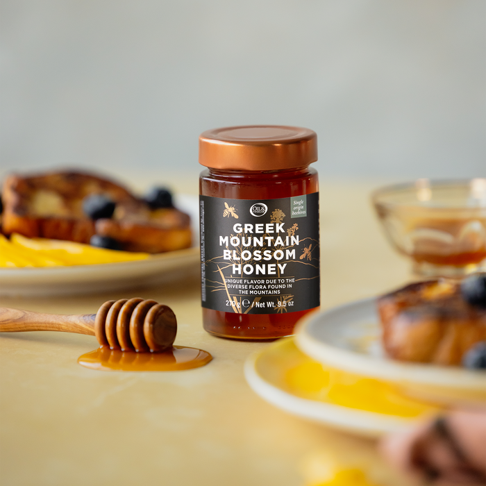 Jar of Greek Mountain Blossom Honey on a table with breakfast items