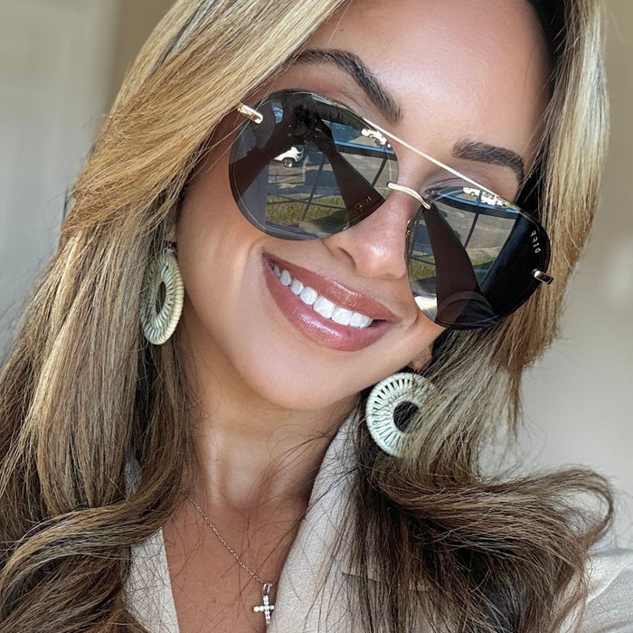 UGC - lifestyle - scarlly shannel brunette model with highlights wearing black aviator sunglasses with statement earrings