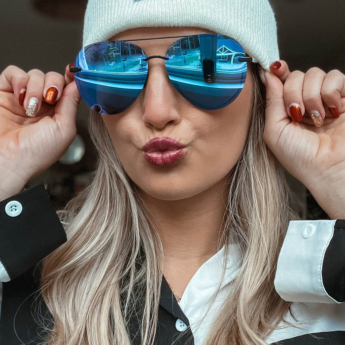 UGC - lifestyle - ambermiller9 with snow cap wearing Lenox sunglasses with matte black frames and purple mirror lens front view