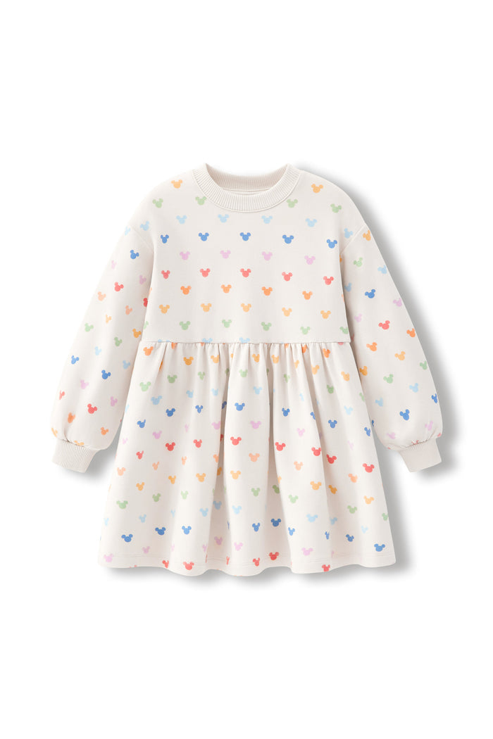A long-sleeve baby dress in cream with a colorful pattern of small mickey heads in pastel shades of blue, pink, orange, and green, displayed on a clean white background.