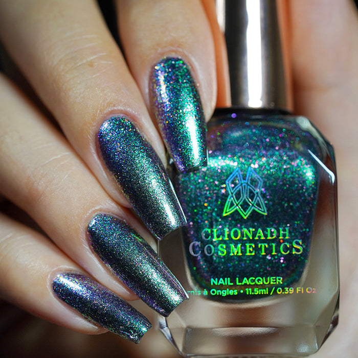 Close up shot of nails done with Oxidize nail lacquer on fair skin tone holding the nail lacquer bottle