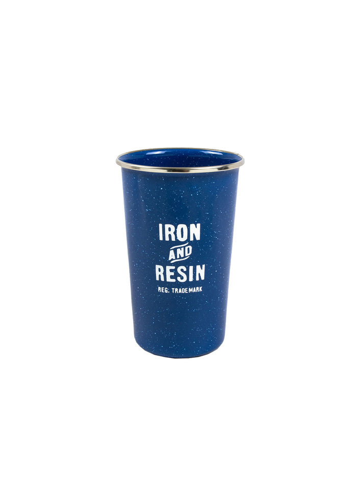 Blue enamel cup with "Iron and Resin" logo in white, featuring a speckled pattern and metallic rim, isolated on white background.