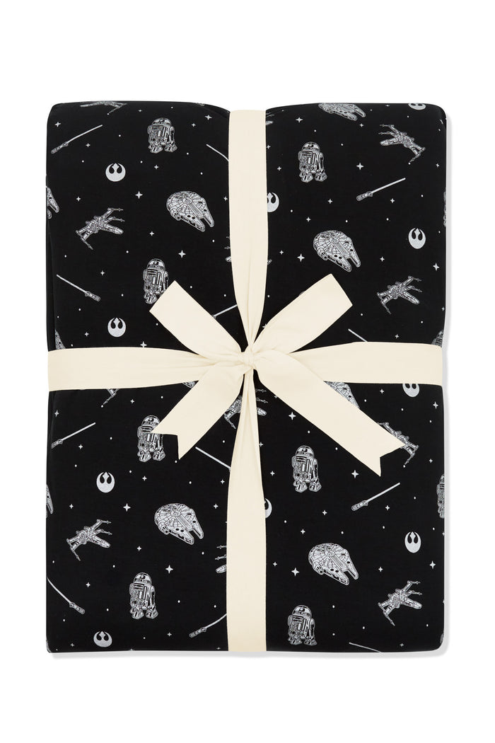 Black blanket with a star wars x kyte baby print featuring space ships
