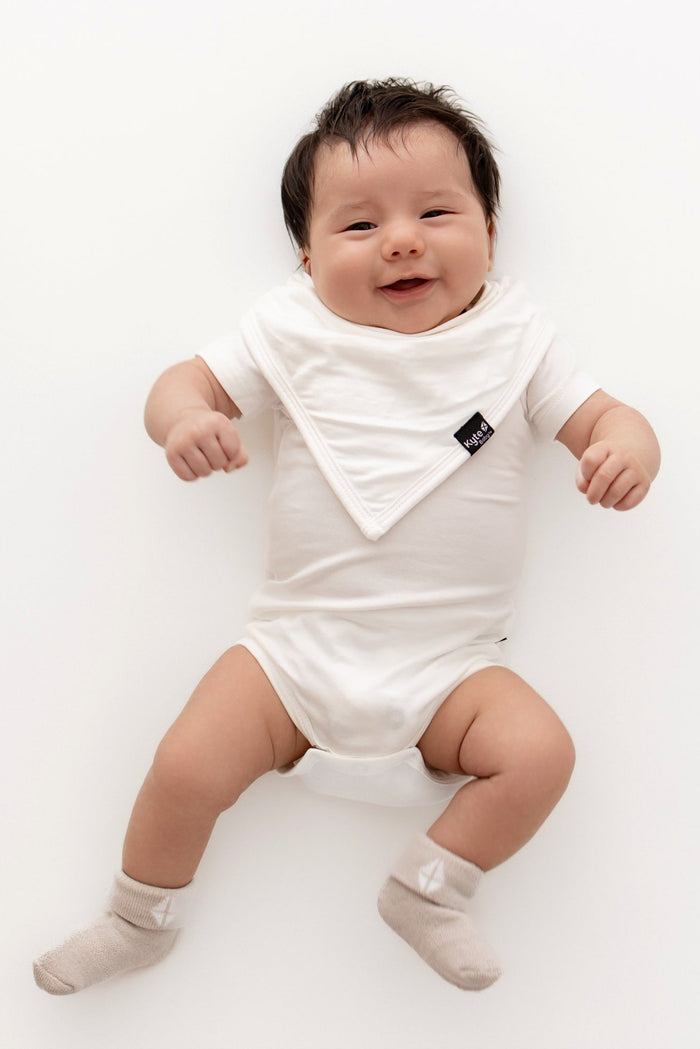 Baby wearing neutral colors with plush infant socks