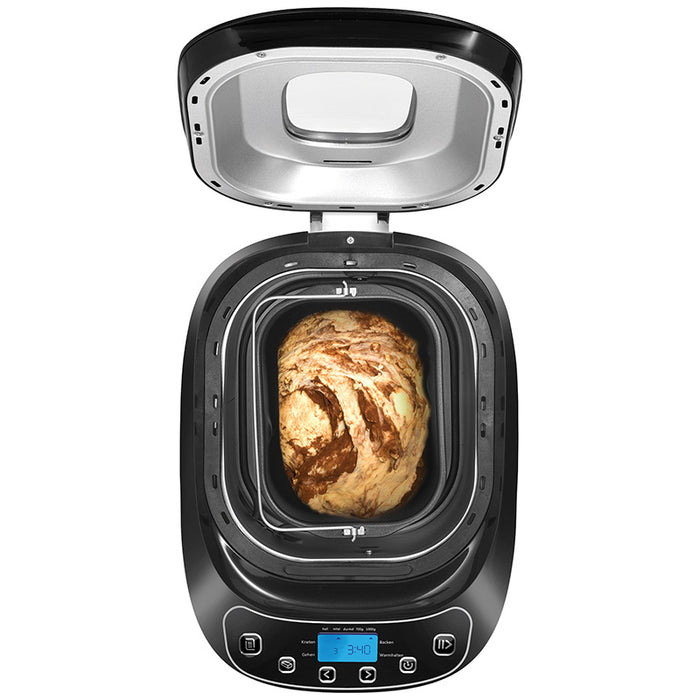 Eine Draufsicht auf den Brotbackautomaten Unold 68010 Backmeister® Design von Unold zeigt den Teig im Inneren, der zum Backen bereit ist. Das Bedienfeld, die Tasten und die Digitalanzeige sind auf der Vorderseite sichtbar.