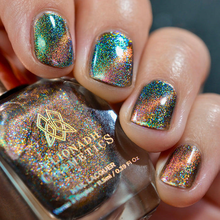 Close-up of nails painted with Baeocystin Nail Lacquer on fair skin tone. Hand is holding polish bottle.