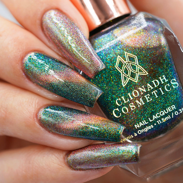 Close-up of nails painted with Baeocystin Nail Lacquer on fair skin tone. Hand is holding polish bottle.