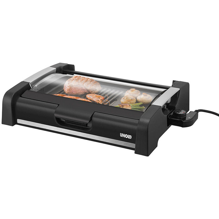 Der Unold Barbecue-Grill Edel ist ein schwarzer Elektrogrill mit Glasdeckel, seitlichem Bedienknopf und „Unold“-Schriftzug auf der Vorderseite, ideal zum Garen von Fleisch, Fisch und Gemüse.