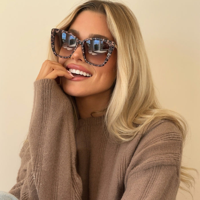 lifestyle-shelby hunstad wearing becky ii leopard print oversized cat eye sunglasses with fall fashion knit light brown sweater