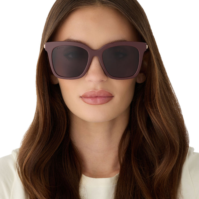 on model - female wearing diff eyewear bella oversized square sunglasses with a rugby red acetate and gold metal frame with grey lenses front view