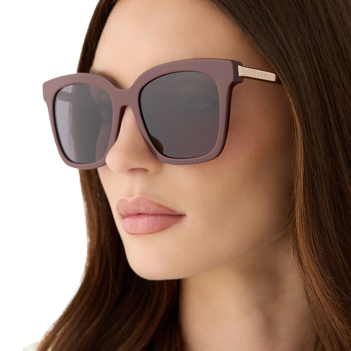 on model - female wearing diff eyewear bella oversized square sunglasses with a rugby red acetate and gold metal frame with grey lenses detailed view