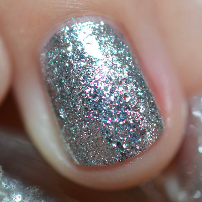 Close-up of one nail painted with Broken Mirror Nail Lacquer on fair skin tone.