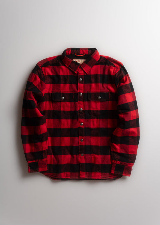 Red and black plaid flannel shirt with buttoned pockets, laid flat on a light background, showcasing its classic design.
