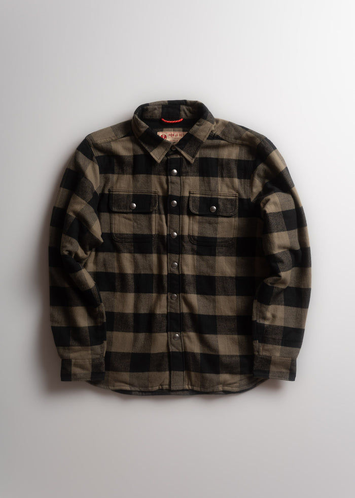 Black and brown plaid flannel shirt with button closure, two chest pockets, and a collar, laid flat on a white background.