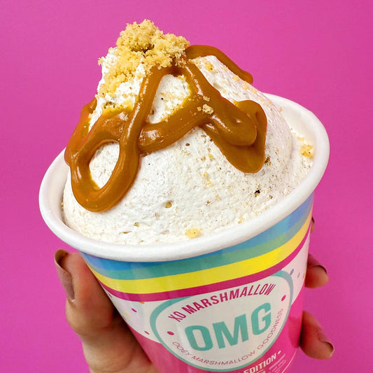 Butterscotch Brown Butter Gourmet Marshmallow Creme in a ice cream pint with a bright pink background