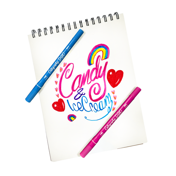 Stylized hand lettering that says "Candy & Ice Cream" on a white pad made with OOLY Calligraphy Duo Double-Ended Markers