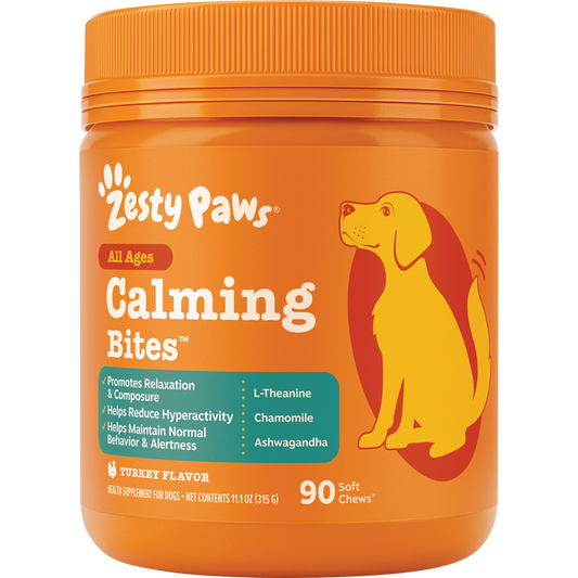Orange plastic jar of Zesty Paws Calming Bites dog treats with yellow and red dog illustration and orange screw-top lid.