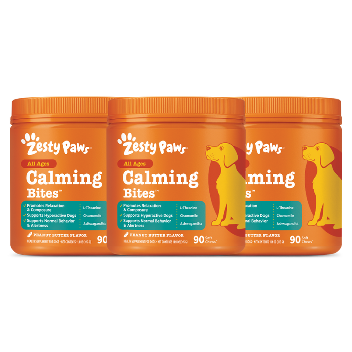 Three orange Zesty Paws Calming Bites containers with peanut butter flavor and yellow dog illustrations on the labels.