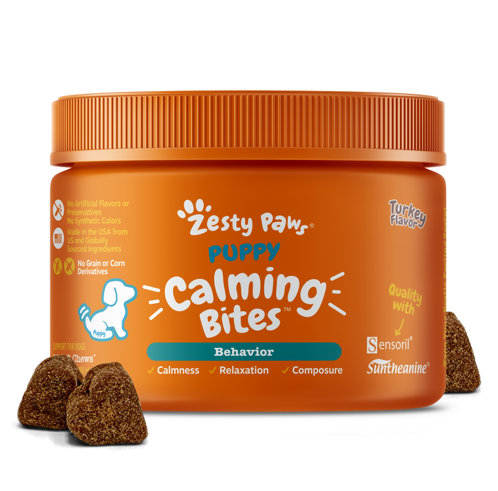 Orange jar of Zesty Paw puppy calming bites with brown textured treats displayed in front.
