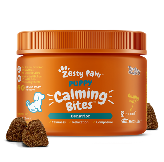 Orange jar of Zesty Paw puppy calming bites with brown textured treats displayed in front.