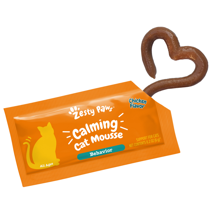 Orange sachet of Zesty Paw calming cat mousse with chicken flavor and brown heart-shaped treat on top.