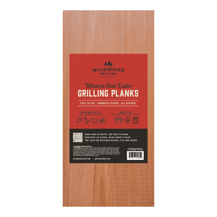 Wooden grilling plank with red label featuring Wildwood Grilling branding.