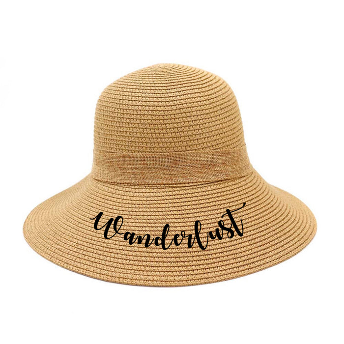 Personalized straw hat for women with Wanderlust text in black script by Travellers Hat Boutique