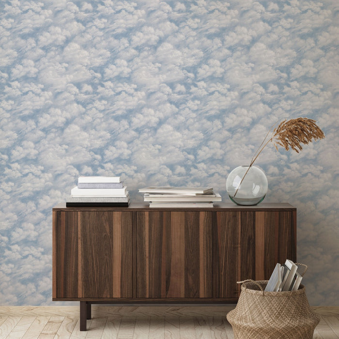 Tempaper's Clouds Peel And Stick Wallpaper in light blue shown behind a sideboard.