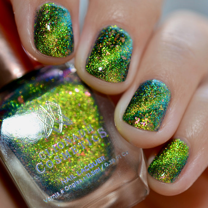 Close-up of nails painted with Conocybe Nail Lacquer on fair skin tone. Hand is holding polish bottle.