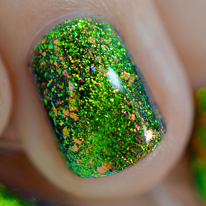 Close-up of one nail painted with Conocybe Nail Lacquer on fair skin tone. Emphasizes flakey glitter.