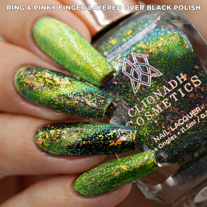 Close-up of nails painted with Conocybe Nail Lacquer on fair skin tone. Hand is holding polish bottle.