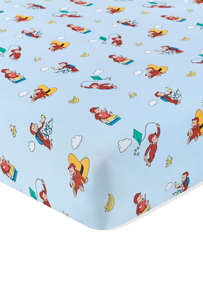 Blue Crib Sheet in Curious George print on a white background