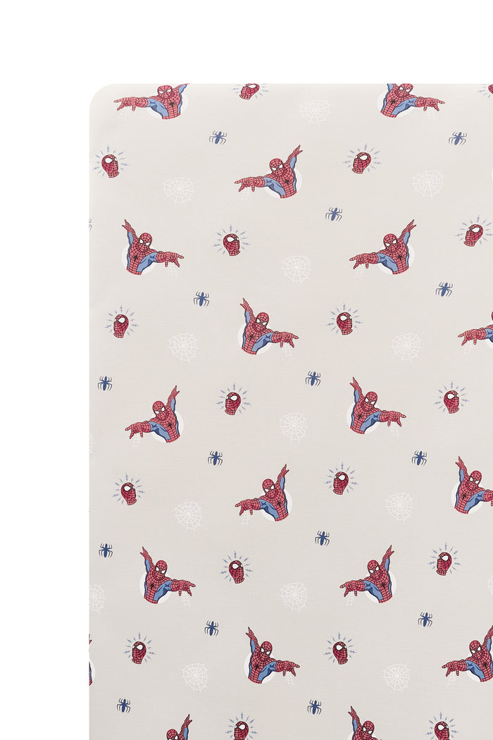 Close up of Oat Crib Sheet with Spider-Man print on a white background