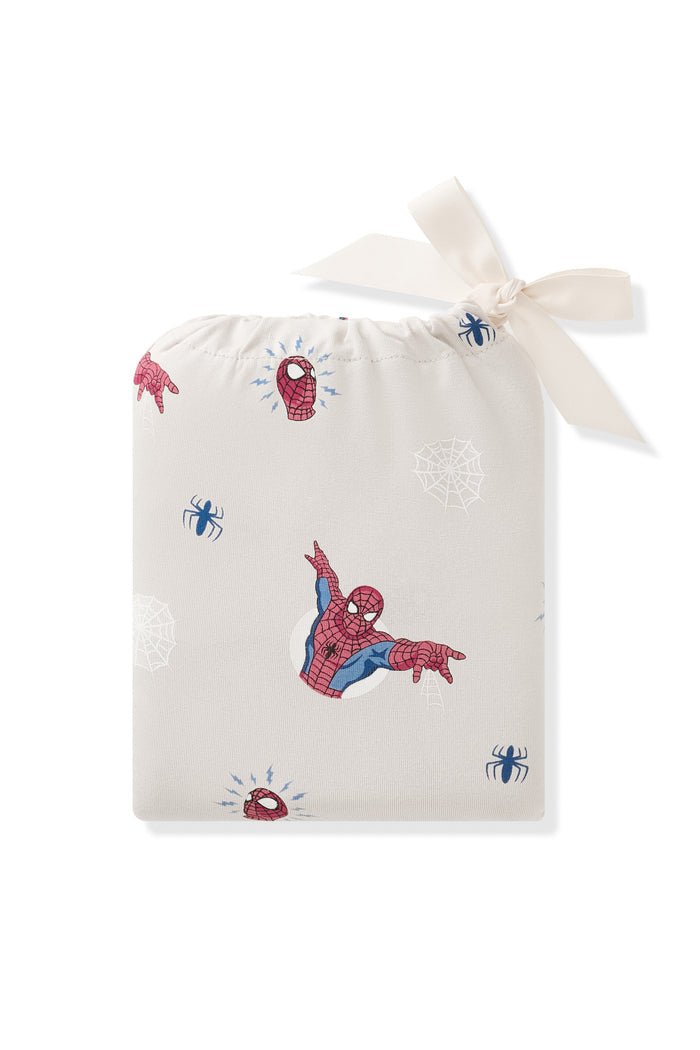 Crib Sheet in Spider-Man packed in an oat bag with Spider-Man print on a white background