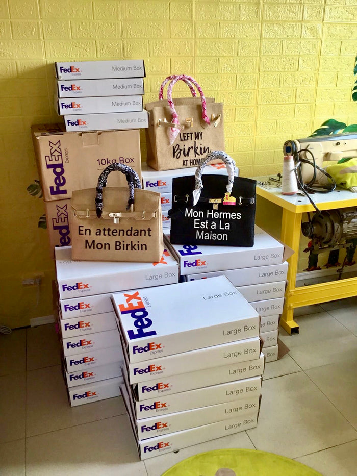35cm printed burlap bag collection from Travellers Hat Boutique displayed near stacked FedEx boxes