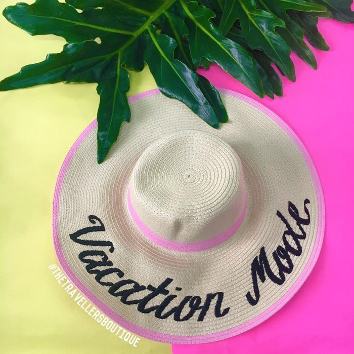 Custom hand-painted floppy hat with Vacation Mode text and pink trim from Travellers Hat Boutique