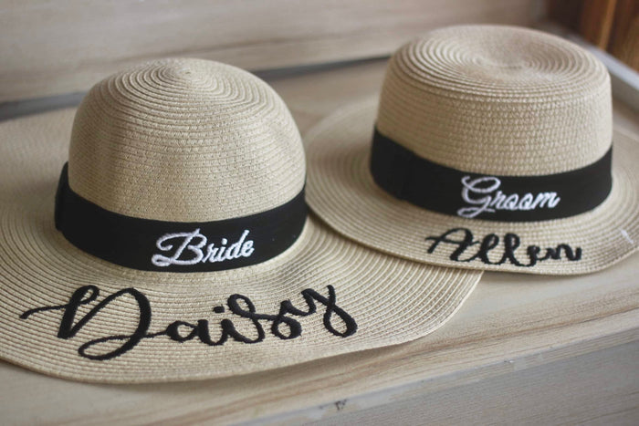 Custom prenuptial hat set with Bride and Groom straw hats featuring black bands and personalized names