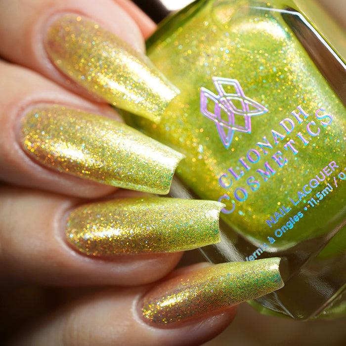 Close-up of nails painted with Dais Nail Lacquer on fair skin tone. Hand is holding polish bottle.