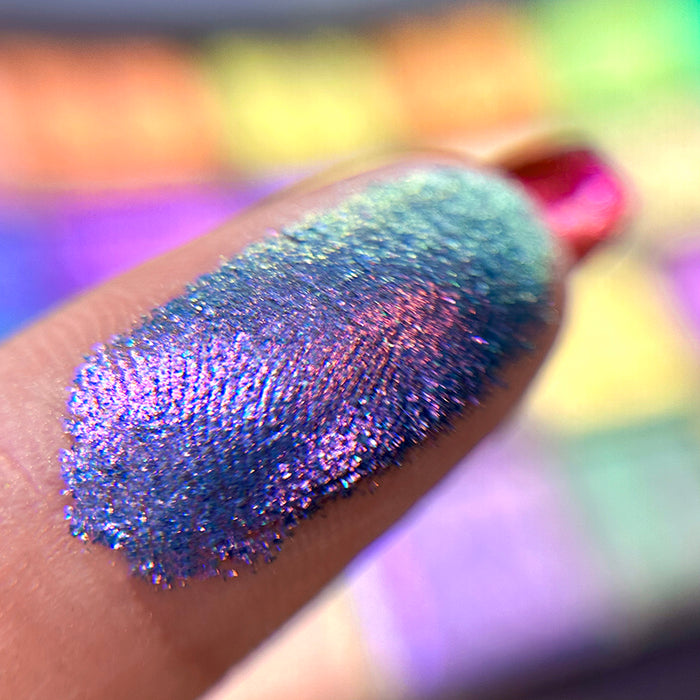 Macro finger swatch of Dynasty Glitter Vibrant Multichrome Eyeshadow.