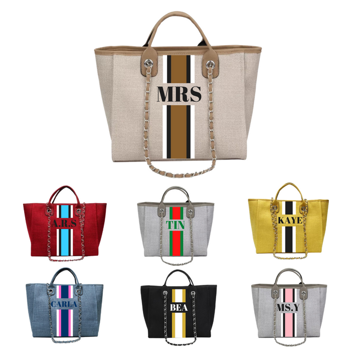 Collection of custom monogram tote bags from Travellers Hat Boutique in various colors with personalized initials