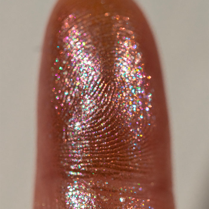Close-up finger swatch of the eyeshadow Exothermic on fair skin tone.