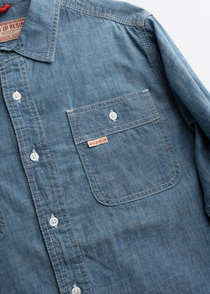 Close up of chest pockets with button flap closure, highlighting stitching and utility design