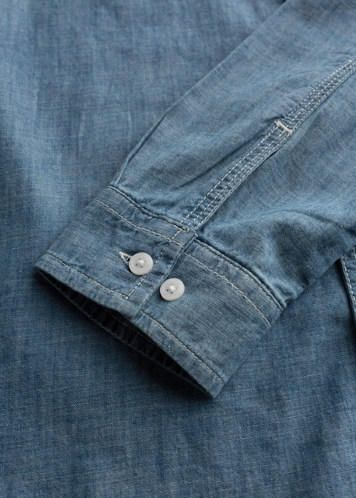 Close up of cuff button detail on shirt sleeve, highlighting clean finish and function