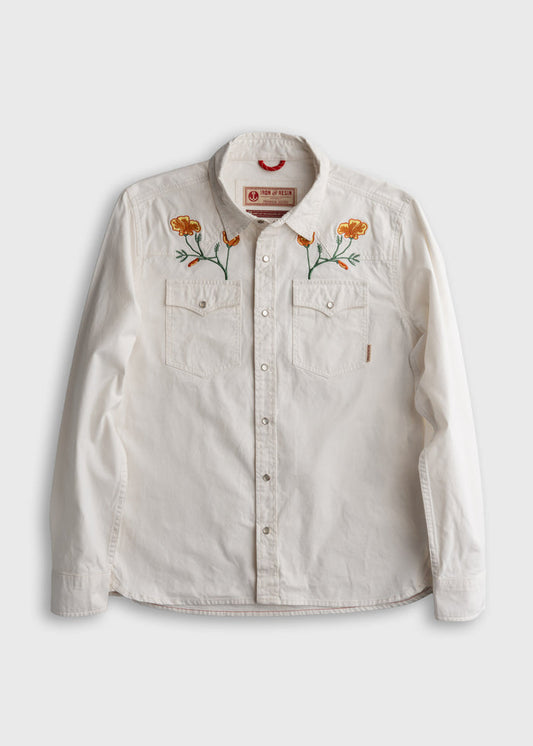 White button-up shirt with orange flower embroidery on the chest, featuring two front pockets.