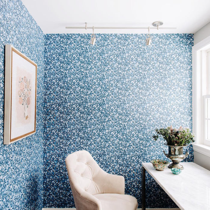 Flamboyan floral wallpaper on the wall of a home office.