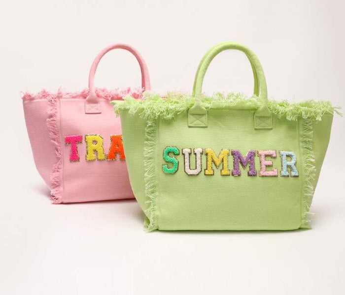 Personalized canvas tote with fringe in green and pink featuring colorful stitched letters by Travellers Hat Boutique