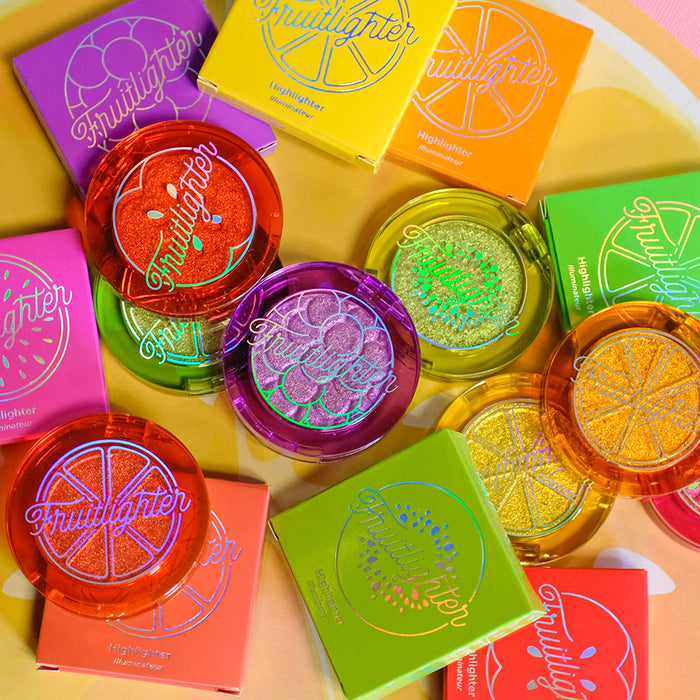 Fruitlighters and their cartons layed out on a fruity background.