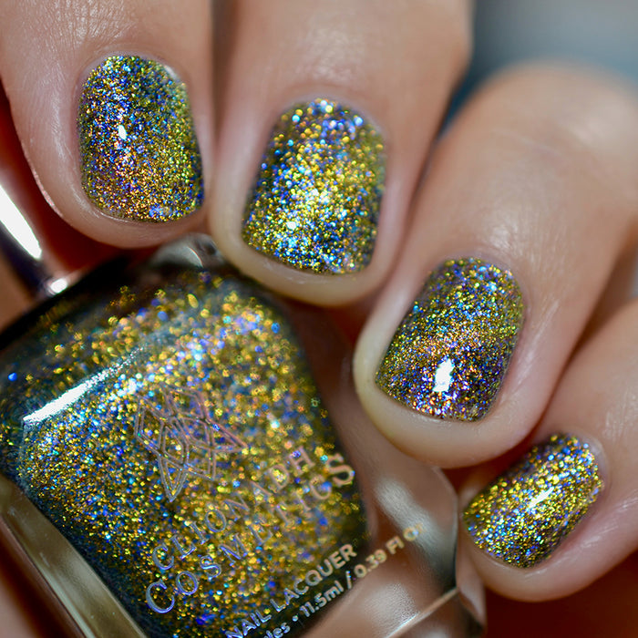 Close-up of nails painted with Galerina Nail Lacquer on fair skin tone. Hand is holding polish bottle.