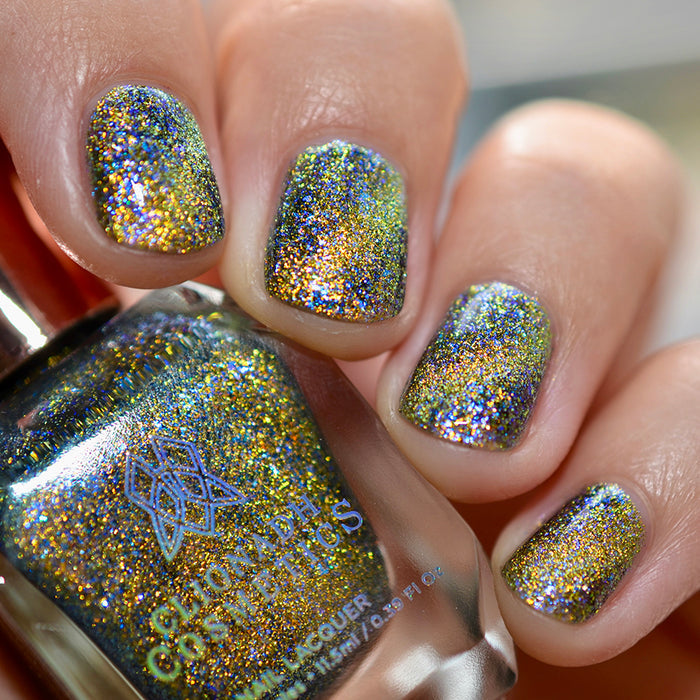 Close-up of nails painted with Galerina Nail Lacquer on fair skin tone. Hand is holding polish bottle.
